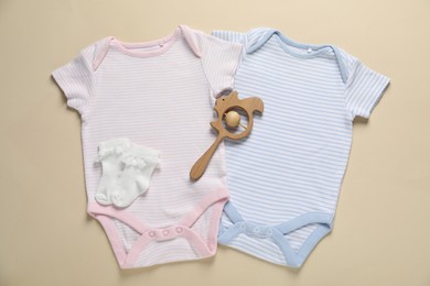 Photo of Stylish baby clothes and accessory on beige background, flat lay