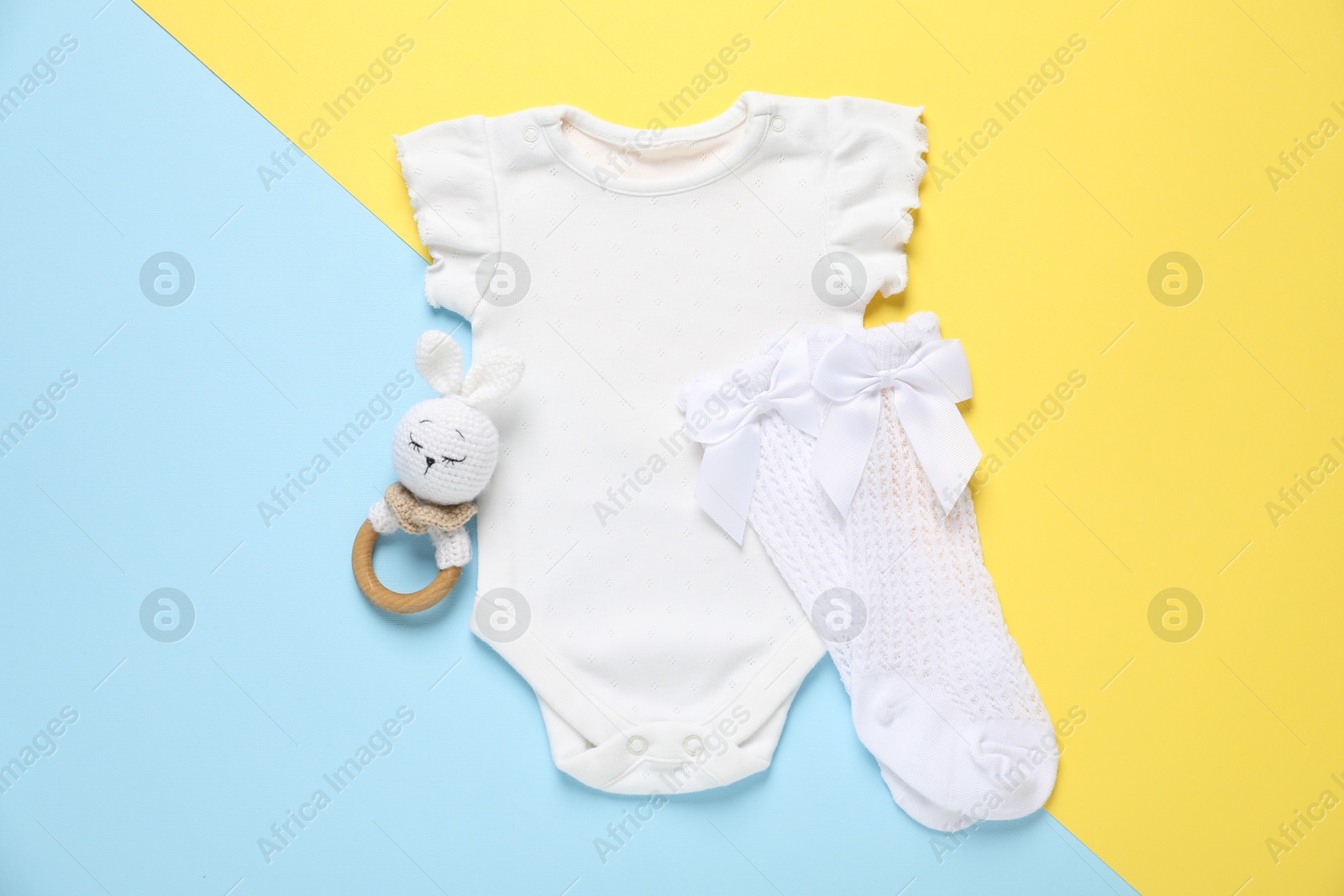 Stylish baby clothes and accessory on color background, flat lay Photo of Stylish baby clothes and accessory on color background, flat lay