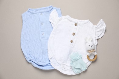 Photo of Stylish baby clothes and accessory on grey background, flat lay