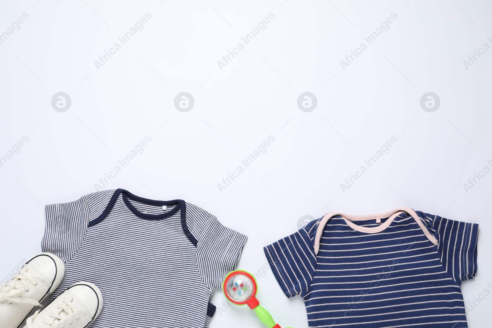 Stylish baby clothes, shoes and accessory on white background, flat lay. Space for text Photo of Stylish baby clothes, shoes and accessory on white background, flat lay. Space for text