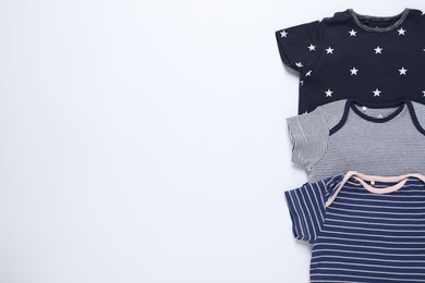 Photo of Stylish baby clothes on white background, flat lay. Space for text