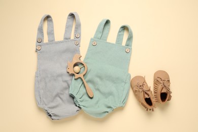 Photo of Stylish baby clothes, shoes and accessory on beige background, flat lay