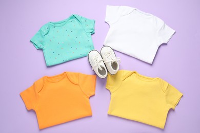 Photo of Stylish baby clothes and shoes on violet background, flat lay
