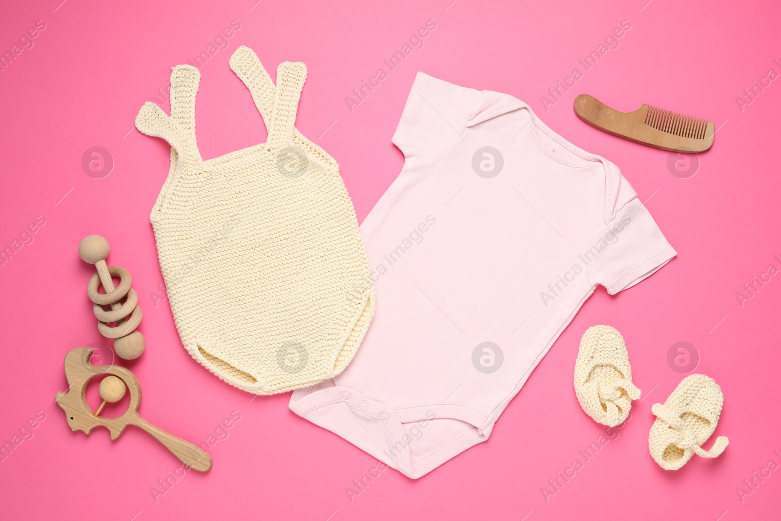 Stylish baby clothes and accessories on pink background, flat lay Photo of Stylish baby clothes and accessories on pink background, flat lay