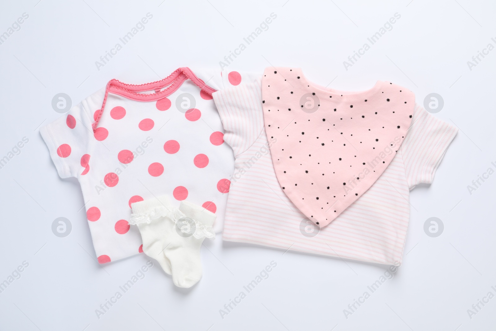 Stylish baby clothes and accessories on white background, flat lay Photo of Stylish baby clothes and accessories on white background, flat lay