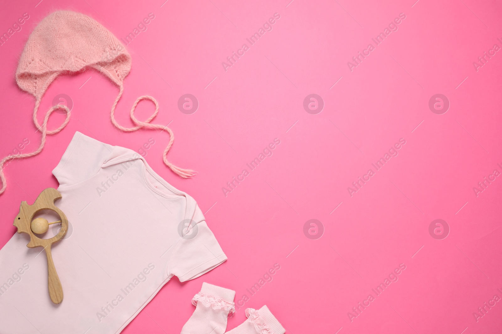 Stylish baby clothes and accessories on pink background, flat lay. Space for text Photo of Stylish baby clothes and accessories on pink background, flat lay. Space for text