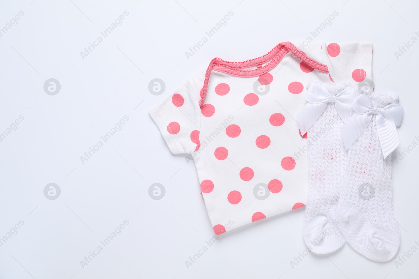 Stylish baby onesie and socks on white background, flat lay. Space for text Photo of Stylish baby onesie and socks on white background, flat lay. Space for text