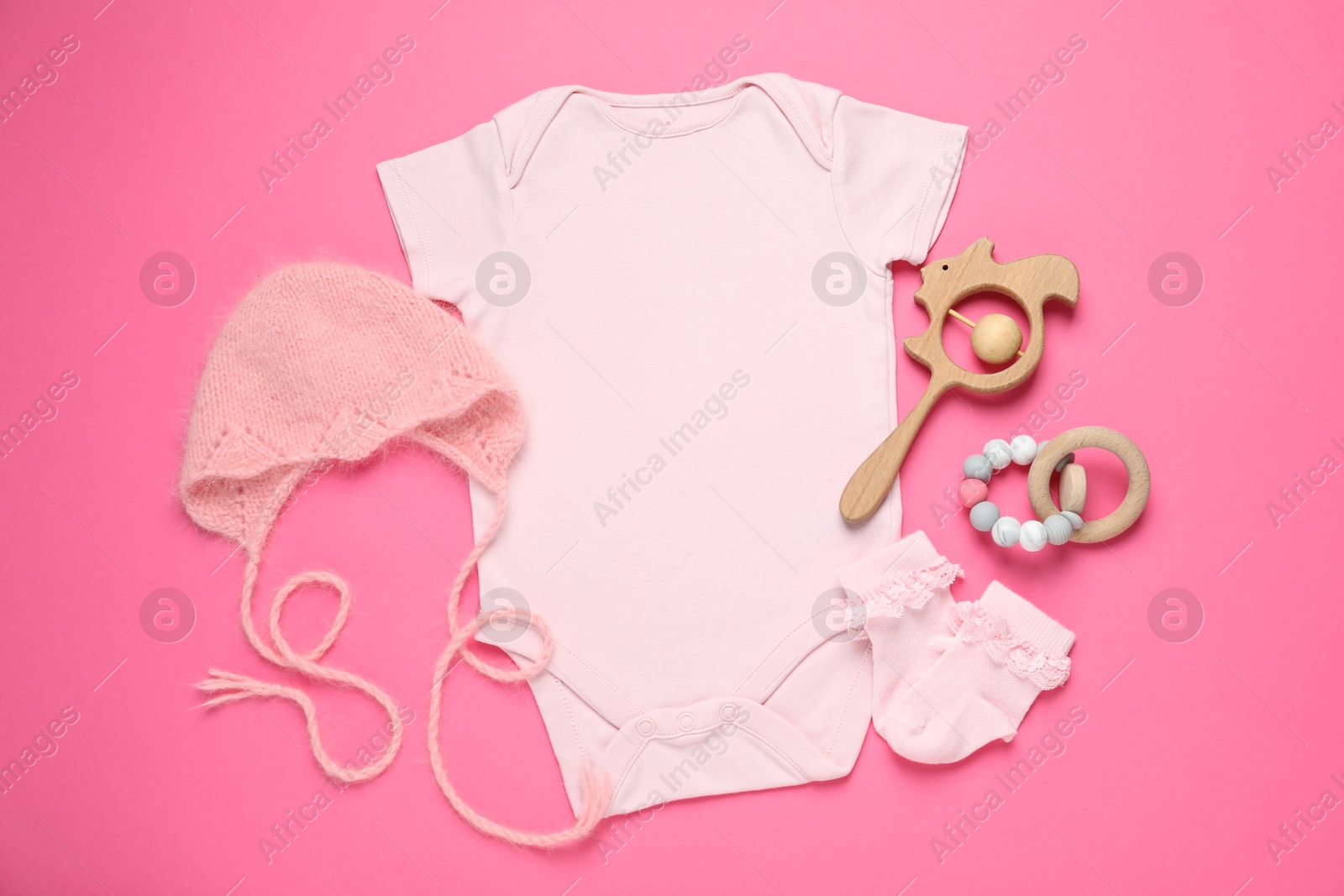 Stylish baby clothes and accessories on pink background, flat lay Photo of Stylish baby clothes and accessories on pink background, flat lay