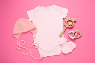 Photo of Stylish baby clothes and accessories on pink background, flat lay