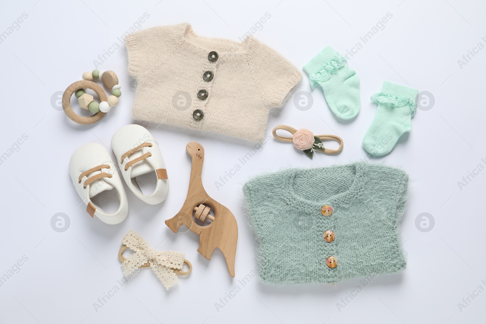 Stylish baby clothes and accessories on white background, flat lay Photo of Stylish baby clothes and accessories on white background, flat lay