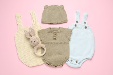 Photo of Stylish baby clothes and accessories on pink background, flat lay