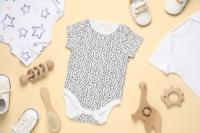 Photo of Stylish baby clothes and accessories on beige background, flat lay