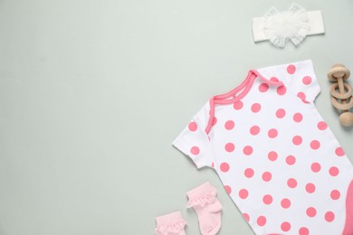 Photo of Stylish baby onesie and accessories on grey background, flat lay. Space for text