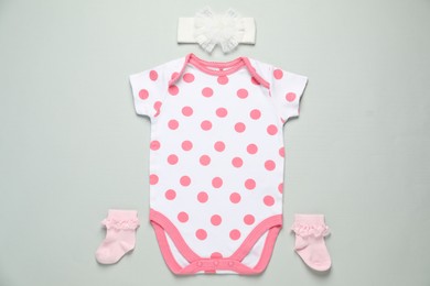 Photo of Stylish baby onesie and accessories on grey background, flat lay