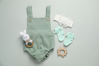 Photo of Stylish baby clothes and accessories on grey background, flat lay