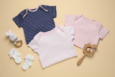 Photo of Stylish baby clothes and accessories on beige background, flat lay