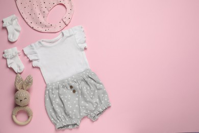 Photo of Stylish baby clothes and accessories on pink background, flat lay. Space for text