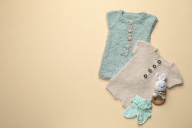Photo of Stylish baby clothes and accessories on beige background, flat lay. Space for text