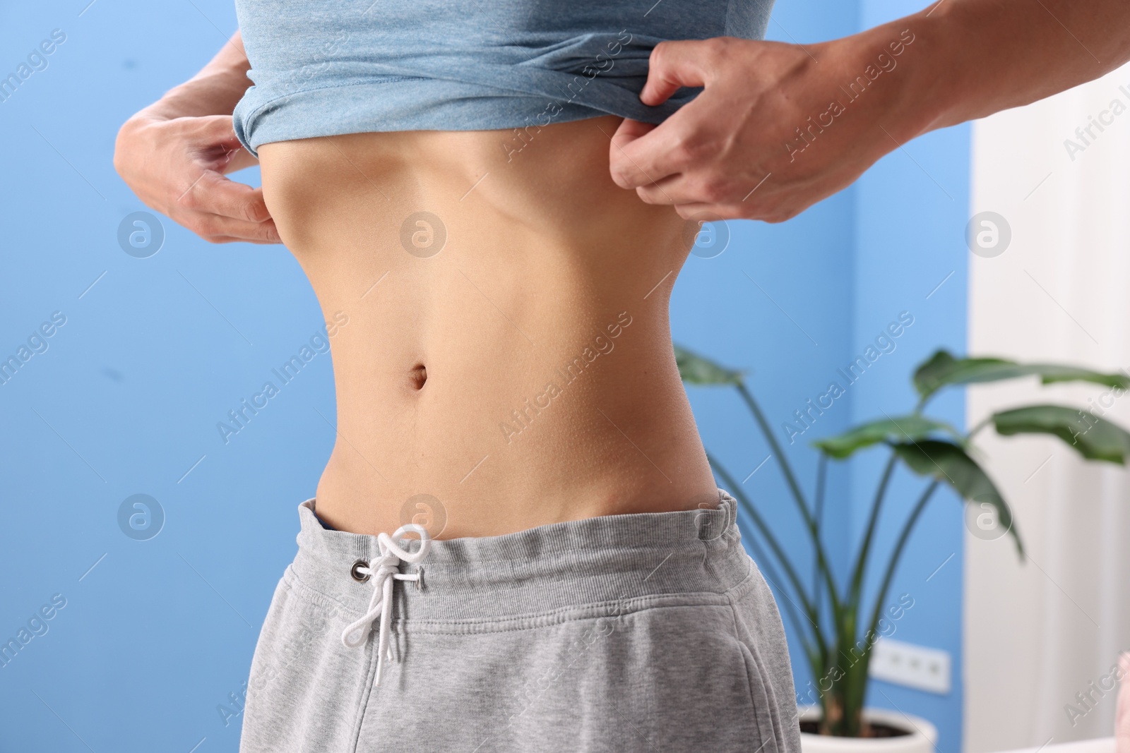 Man doing abdominal vacuum exercise at home, closeup Photo of Man doing abdominal vacuum exercise at home, closeup