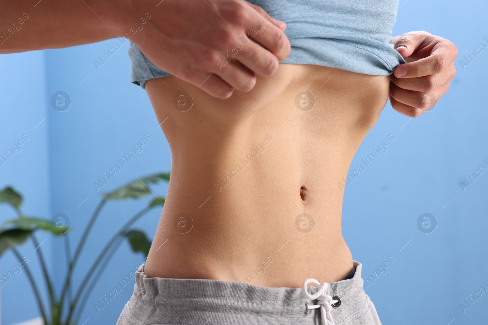 Man doing abdominal vacuum exercise at home, closeup Photo of Man doing abdominal vacuum exercise at home, closeup