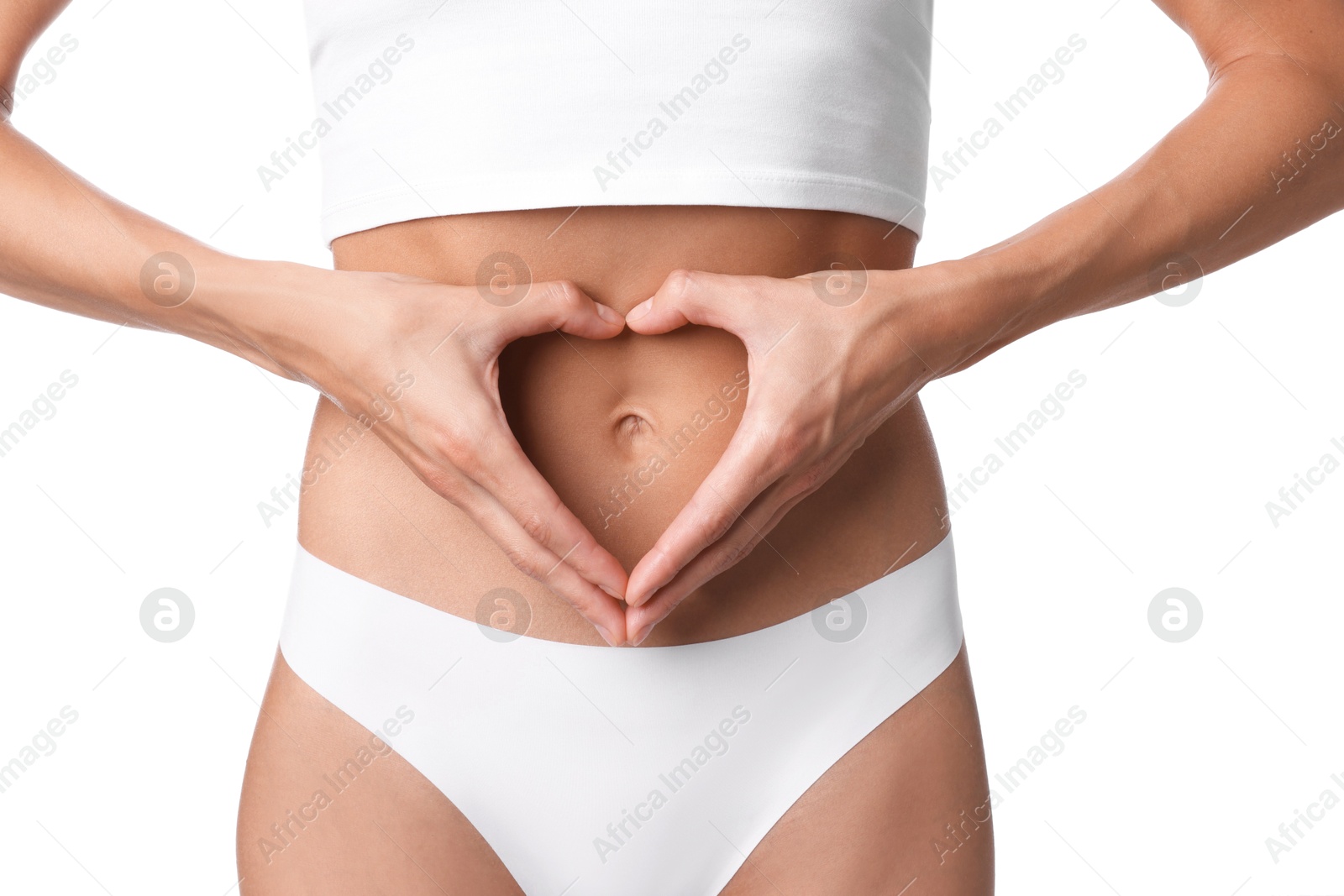 Woman with flat belly making heart gesture on white background, closeup Photo of Woman with flat belly making heart gesture on white background, closeup