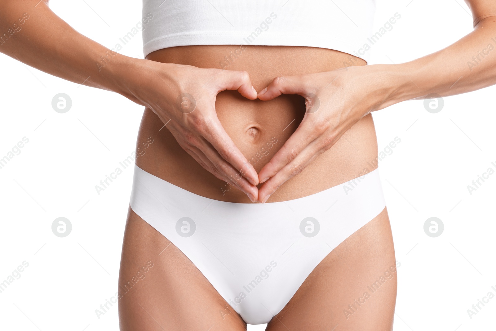 Woman with flat belly making heart gesture on white background, closeup Photo of Woman with flat belly making heart gesture on white background, closeup