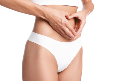 Photo of Woman with flat belly making heart gesture on white background, closeup