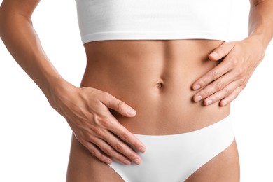 Photo of Woman with flat belly on white background, closeup