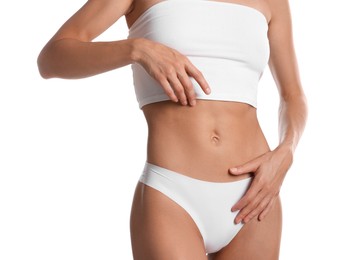 Photo of Woman with flat belly on white background, closeup