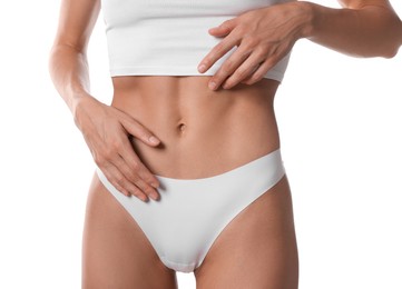 Photo of Woman with flat belly on white background, closeup