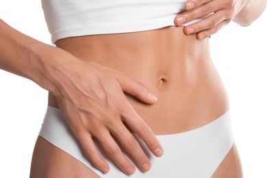 Photo of Woman with flat belly on white background, closeup