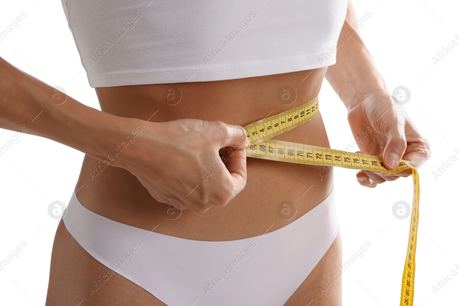 Woman measuring her belly with tape on white background, closeup Photo of Woman measuring her belly with tape on white background, closeup