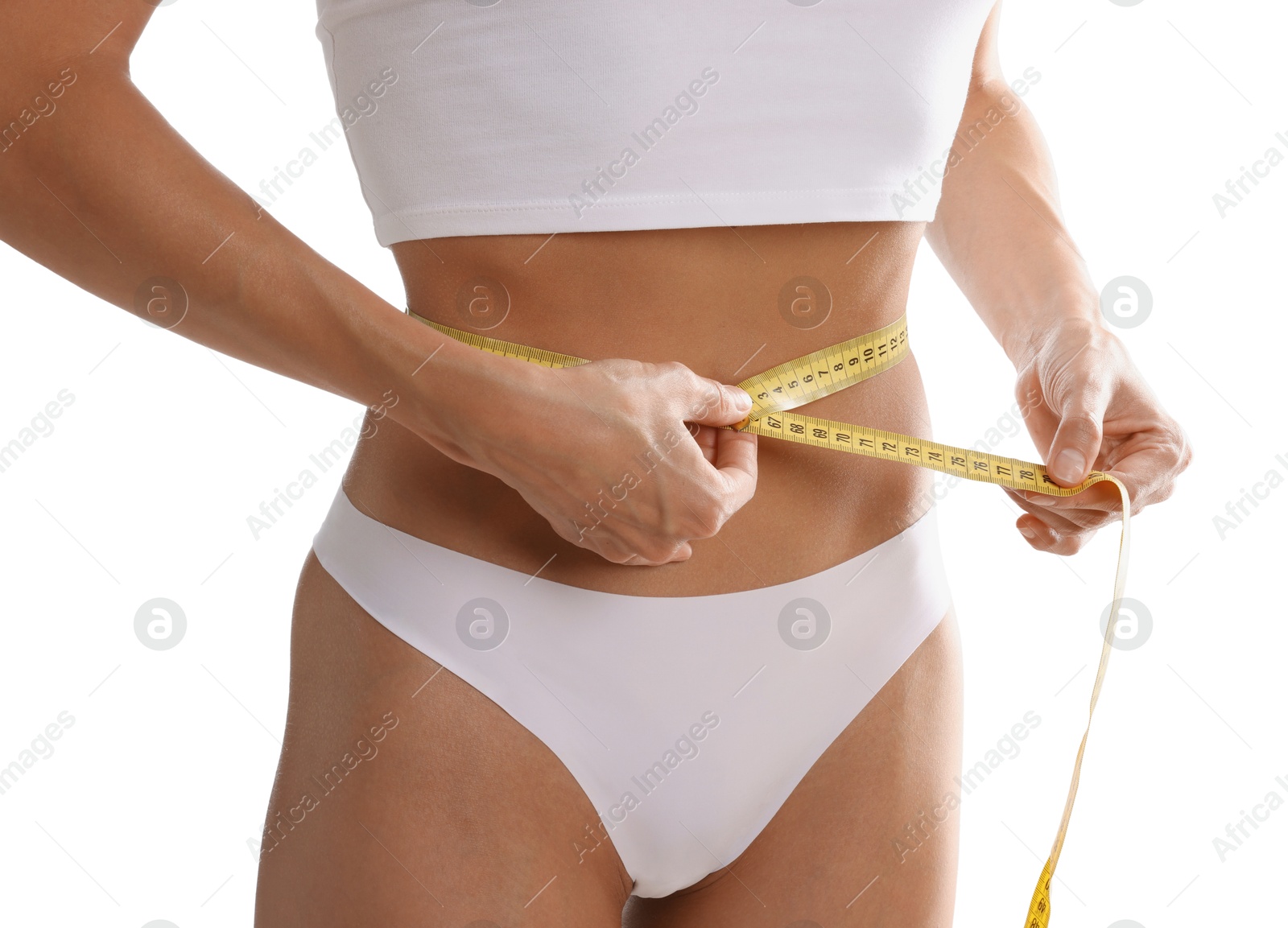 Woman measuring her belly with tape on white background, closeup Photo of Woman measuring her belly with tape on white background, closeup