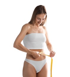 Photo of Woman measuring her belly with tape on white background