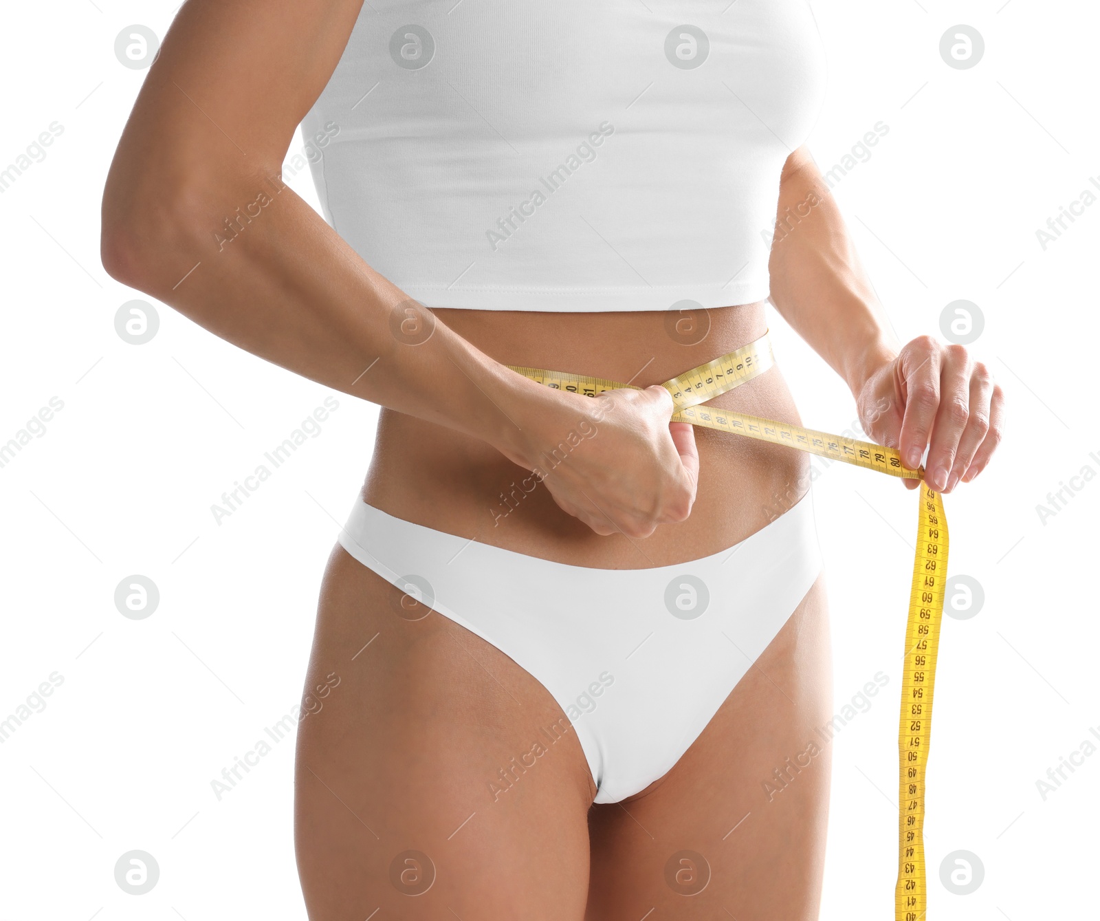 Woman measuring her belly with tape on white background, closeup Photo of Woman measuring her belly with tape on white background, closeup