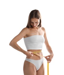 Photo of Woman measuring her belly with tape on white background