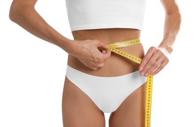 Photo of Woman measuring her belly with tape on white background, closeup