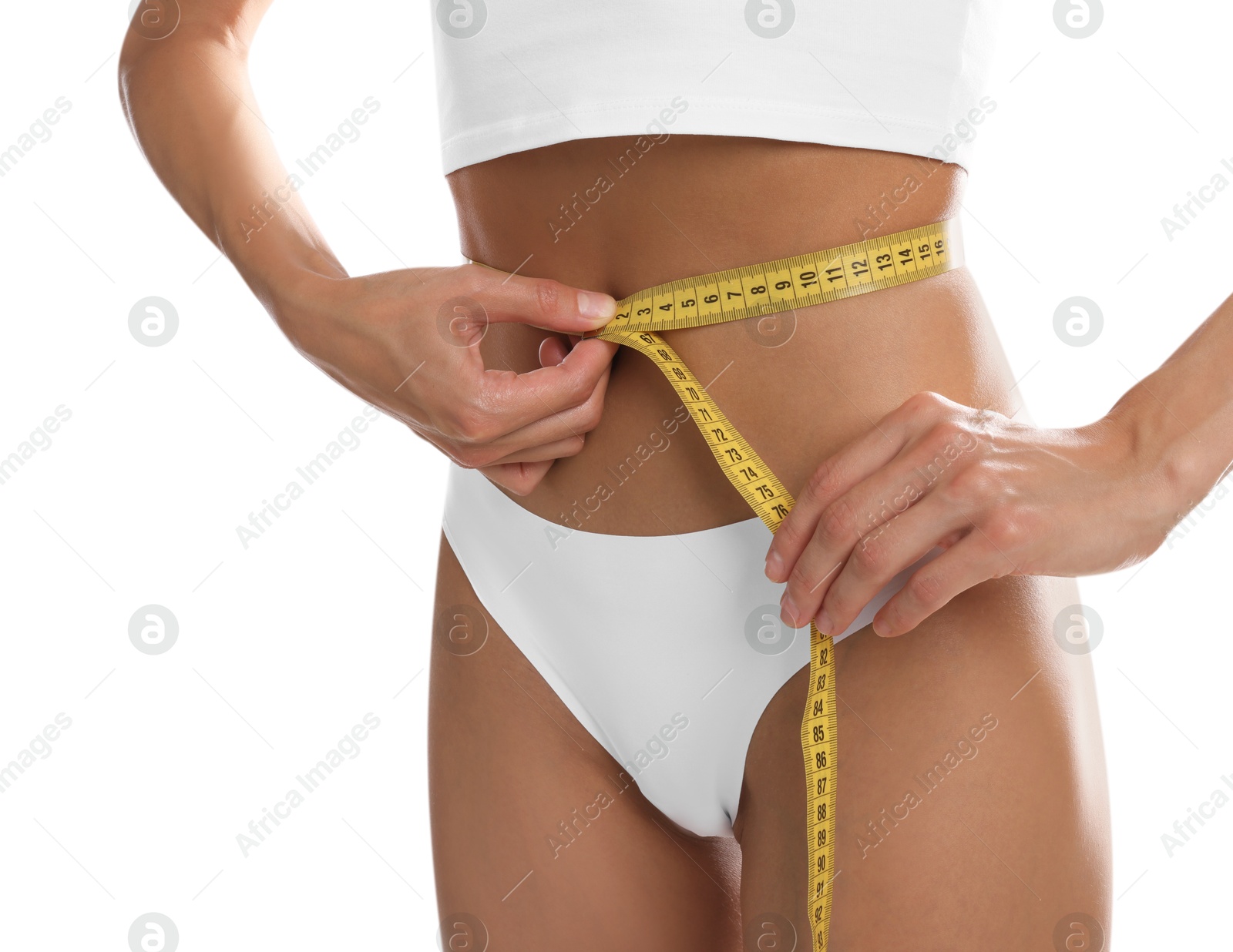 Woman measuring her belly with tape on white background, closeup Photo of Woman measuring her belly with tape on white background, closeup