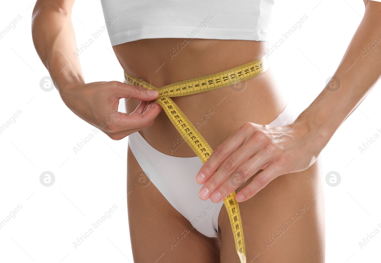 Woman measuring her belly with tape on white background, closeup Photo of Woman measuring her belly with tape on white background, closeup