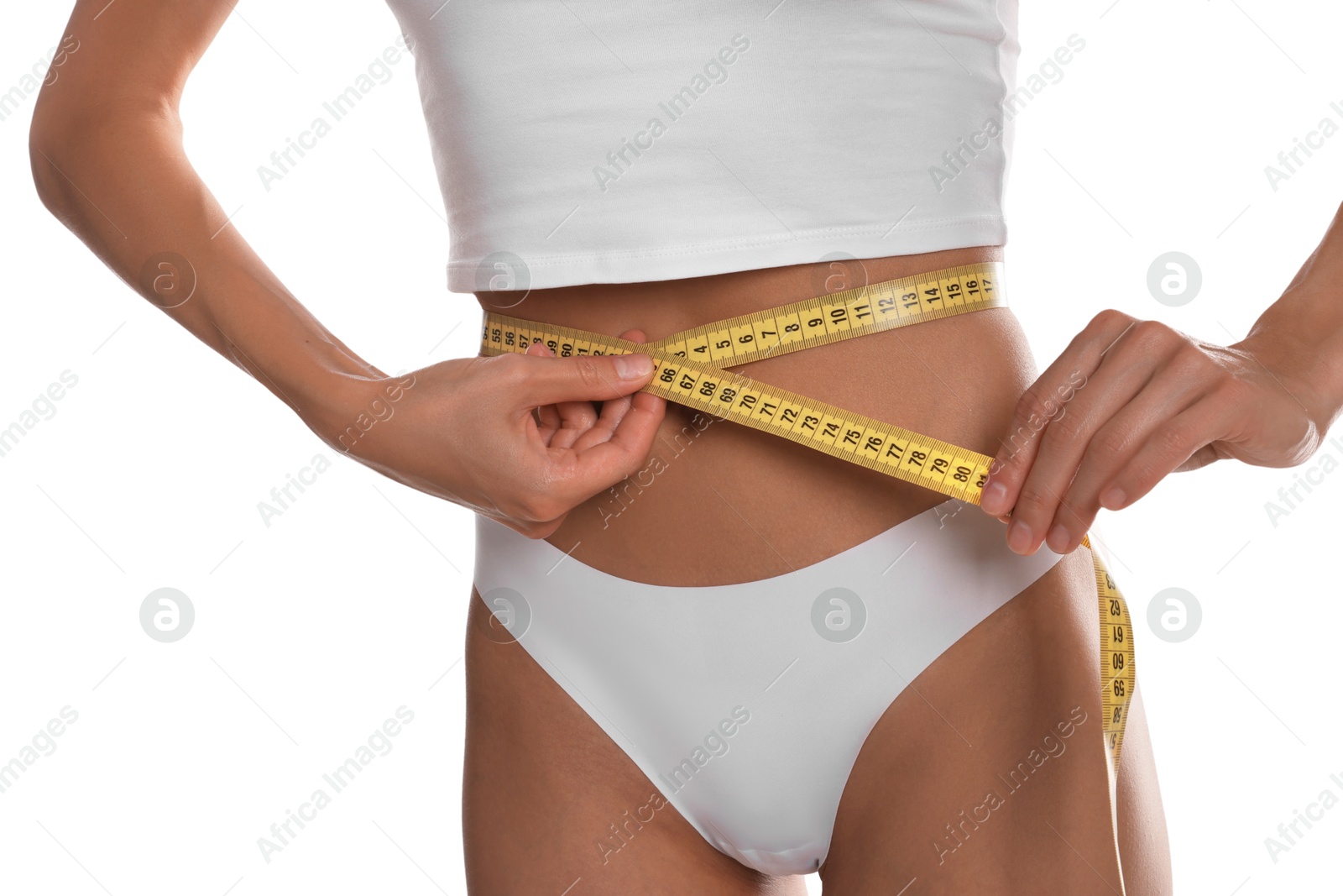 Woman measuring her belly with tape on white background, closeup Photo of Woman measuring her belly with tape on white background, closeup