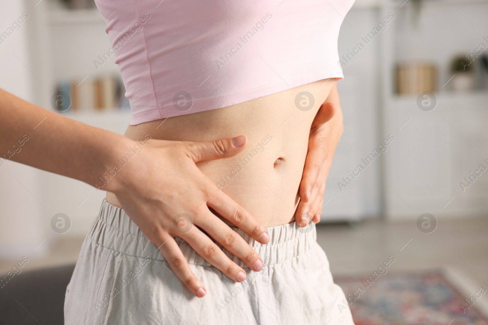 Woman with flat belly at home, closeup Photo of Woman with flat belly at home, closeup