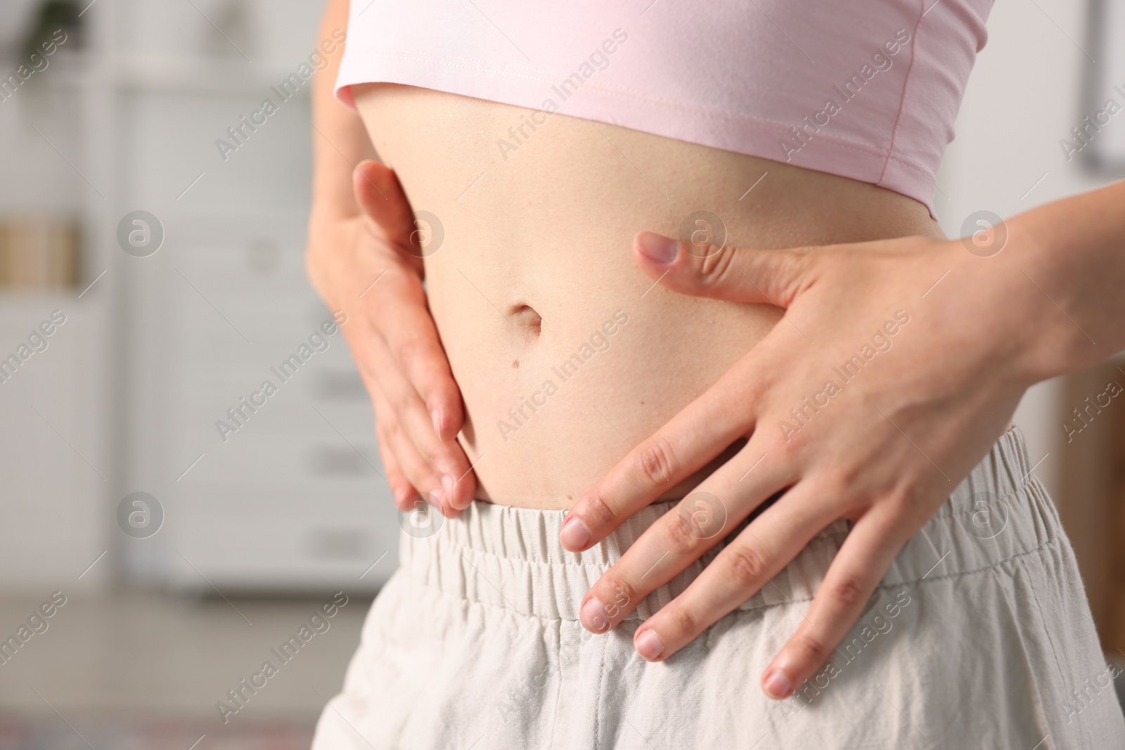 Woman with flat belly at home, closeup Photo of Woman with flat belly at home, closeup