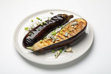 Photo of Slices of grilled eggplant with green onion and blue cheese isolated on white