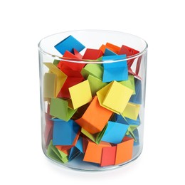 Photo of Many colorful paper pieces in glass isolated on white