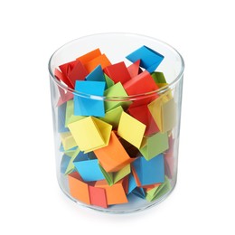 Photo of Many colorful paper pieces in glass isolated on white
