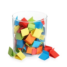 Photo of Many colorful paper pieces in glass isolated on white