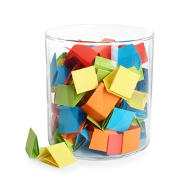 Photo of Many colorful paper pieces in glass isolated on white
