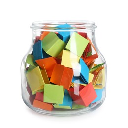 Photo of Many colorful paper pieces in glass jar isolated on white