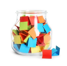 Photo of Many colorful paper pieces in glass jar isolated on white