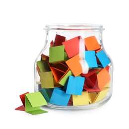 Photo of Many colorful paper pieces in glass jar isolated on white